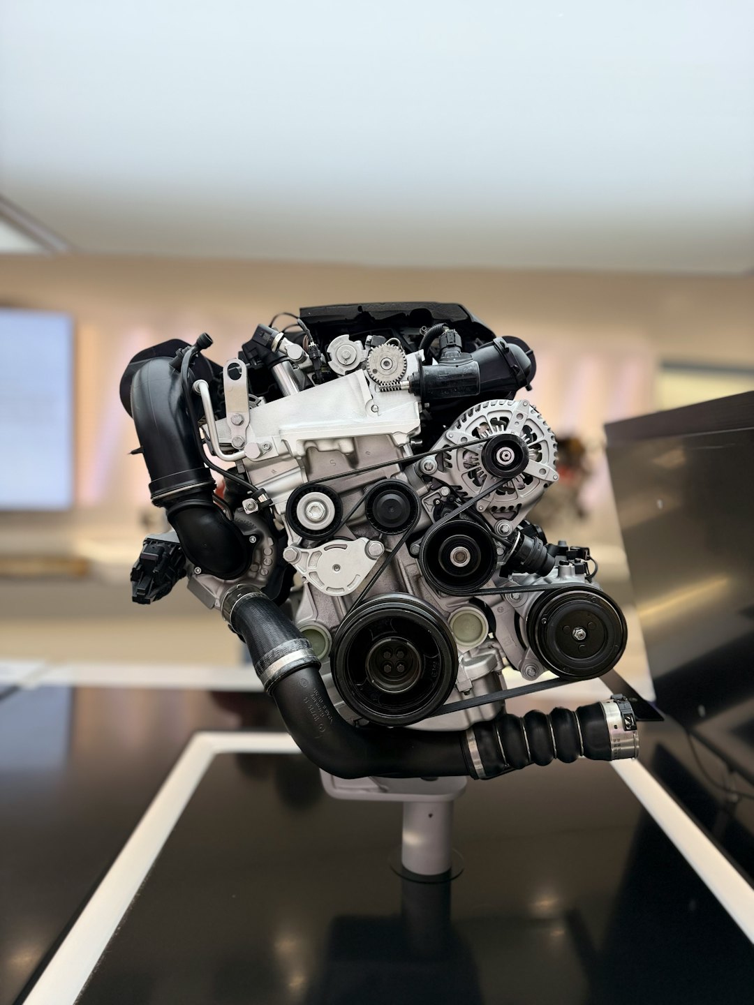 Car engine parts arranged neatly on a display stand.